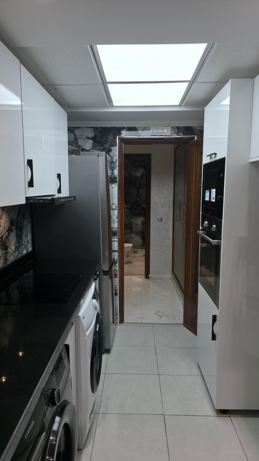 Kitchen or kitchenette, oven, stove, washing machine, dryer