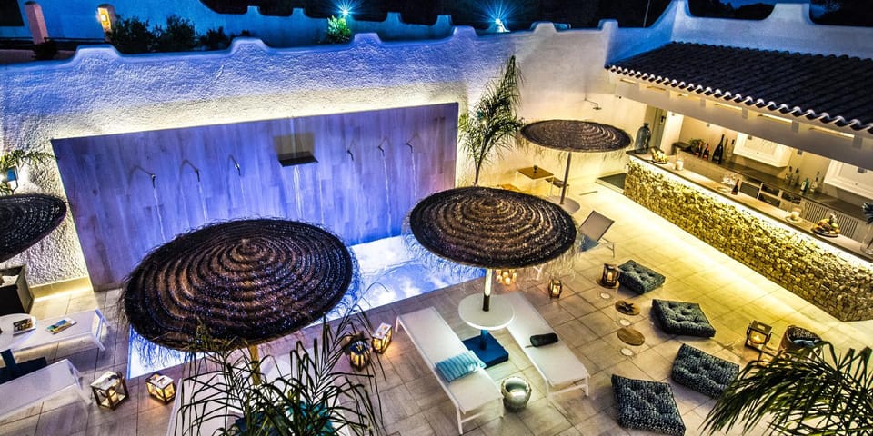 Property building, Patio, Night, Living room, Seating area, Pool view, Swimming pool