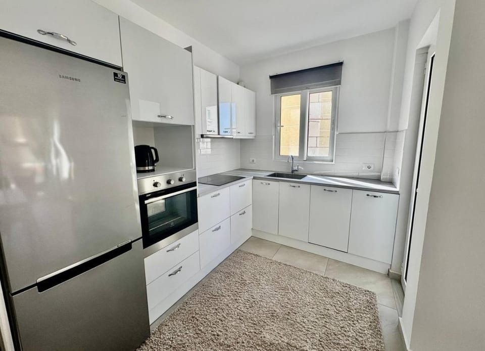 Kitchen or kitchenette, dishwasher, oven, stove
