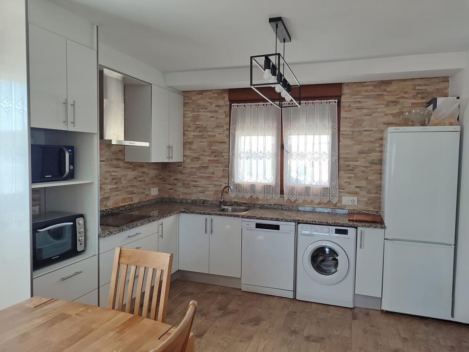 Kitchen or kitchenette, dishwasher, stove, washing machine, dryer