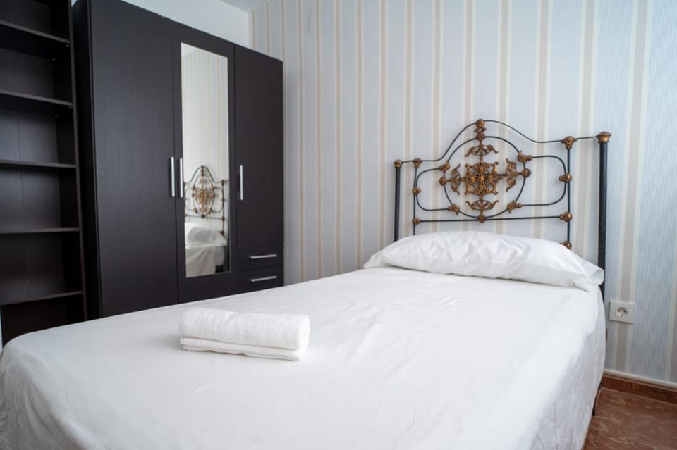 Bed, towels, wardrobe