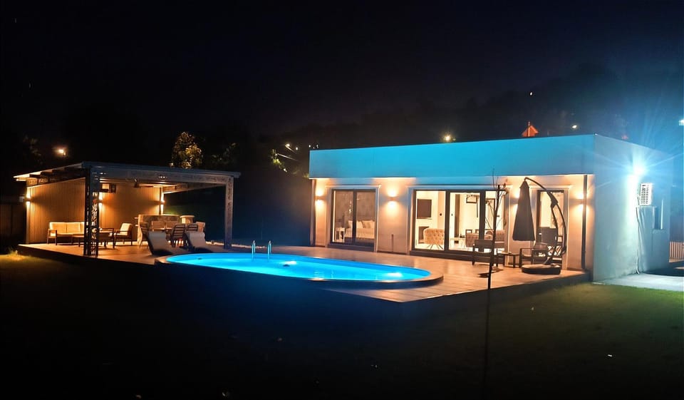 Property building, Patio, Night, Natural landscape, Pool view, Swimming pool, sunbed