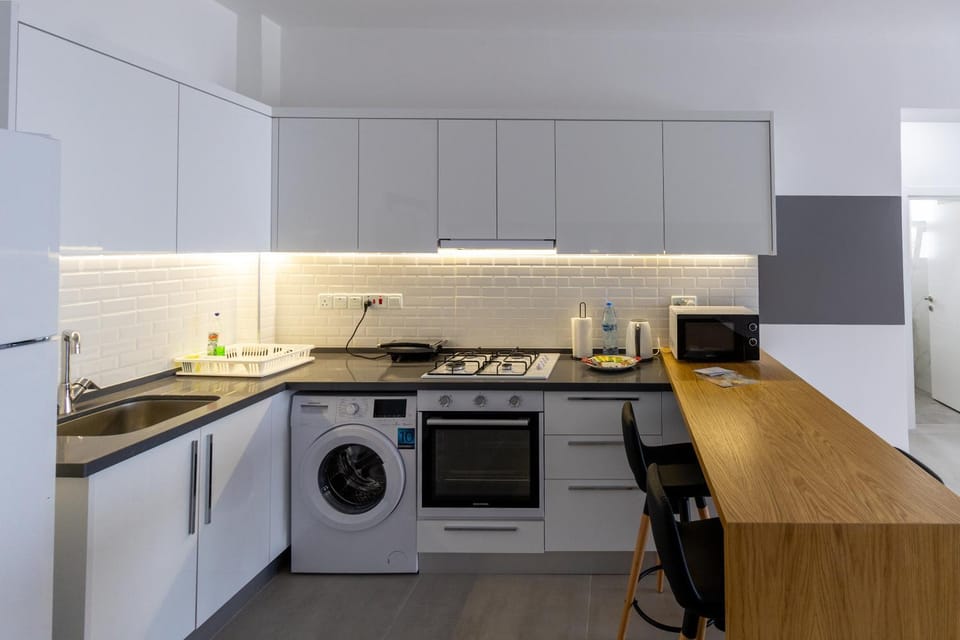 Kitchen or kitchenette, oven, stove, toaster, washing machine