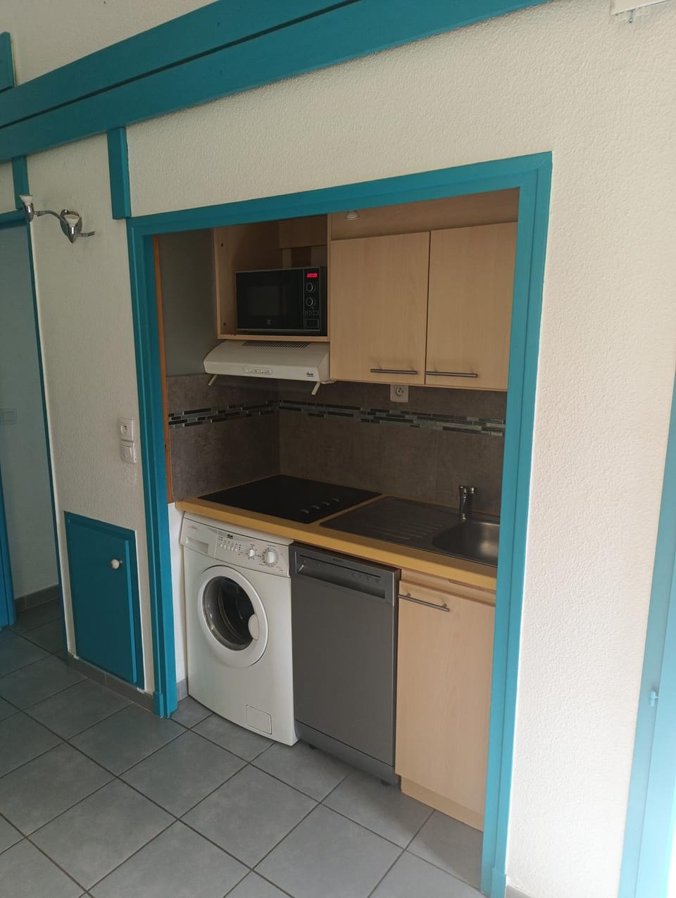 Kitchen or kitchenette, dishwasher, microwave, storage, stove, washing machine