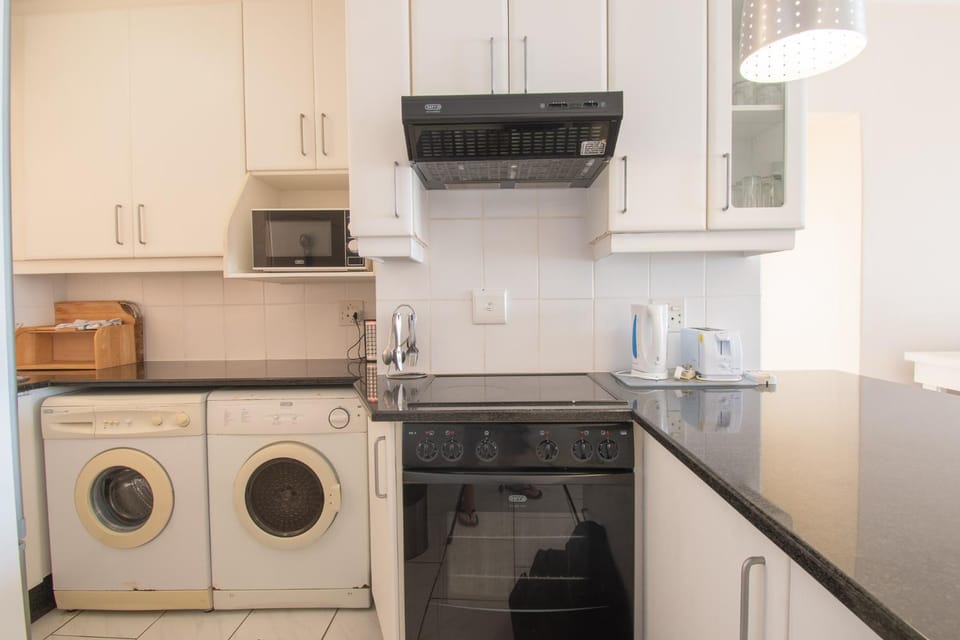 Kitchen or kitchenette, oven, stove, toaster, washing machine, dryer
