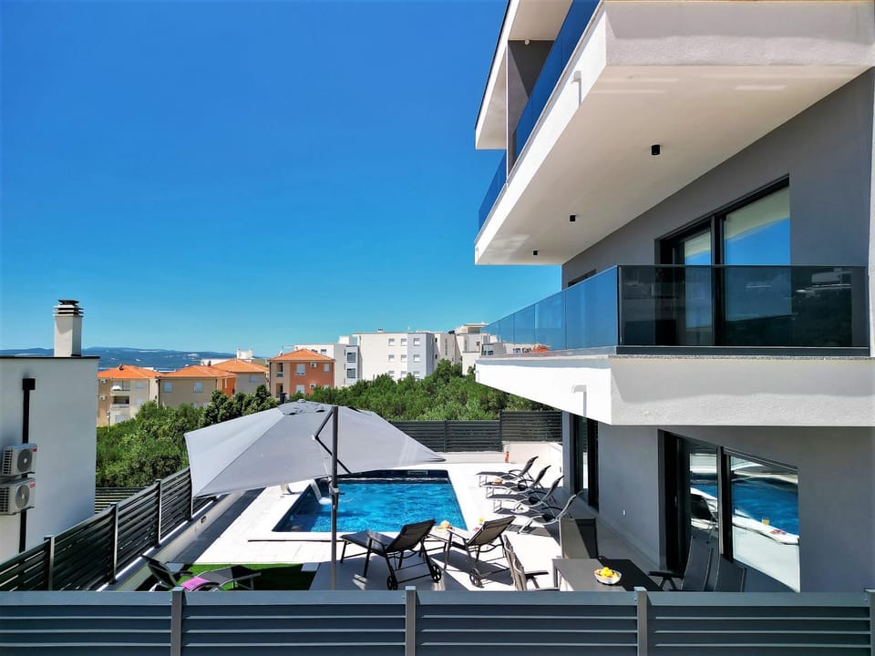 Property building, Patio, View (from property/room), Balcony/Terrace, Pool view, Sea view, Swimming pool, sunbed