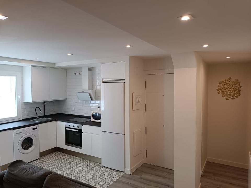 Kitchen or kitchenette, oven, stove, toaster, washing machine