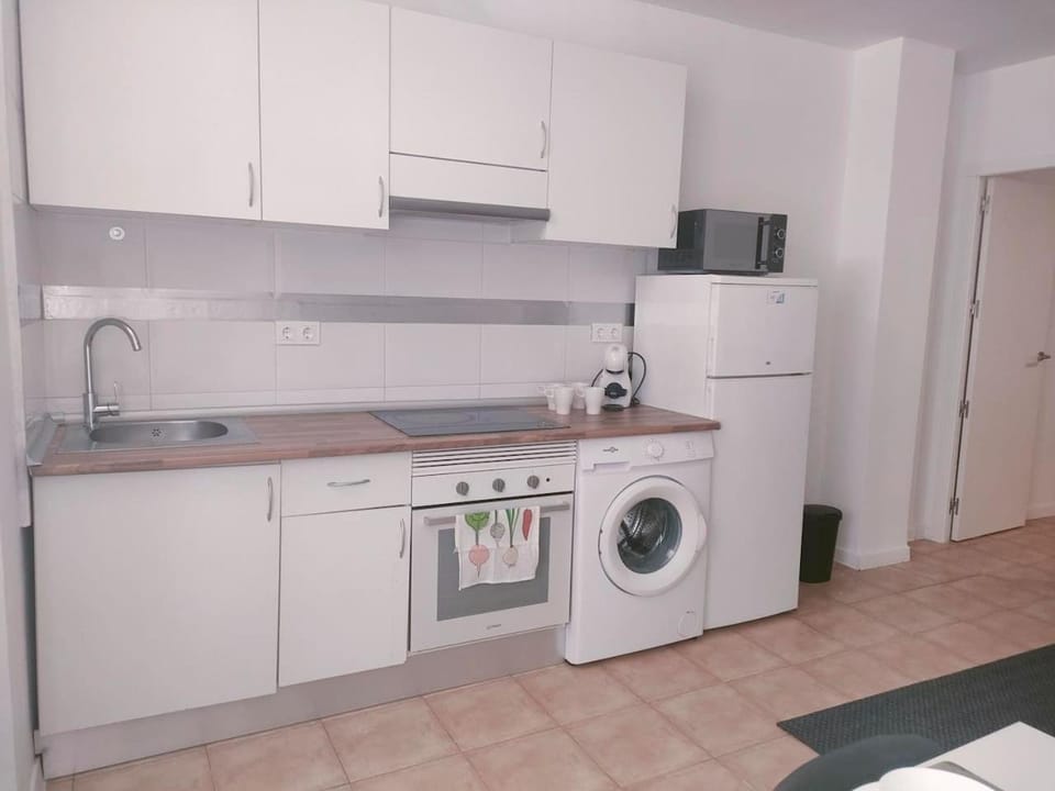 Kitchen or kitchenette, oven, stove, washing machine