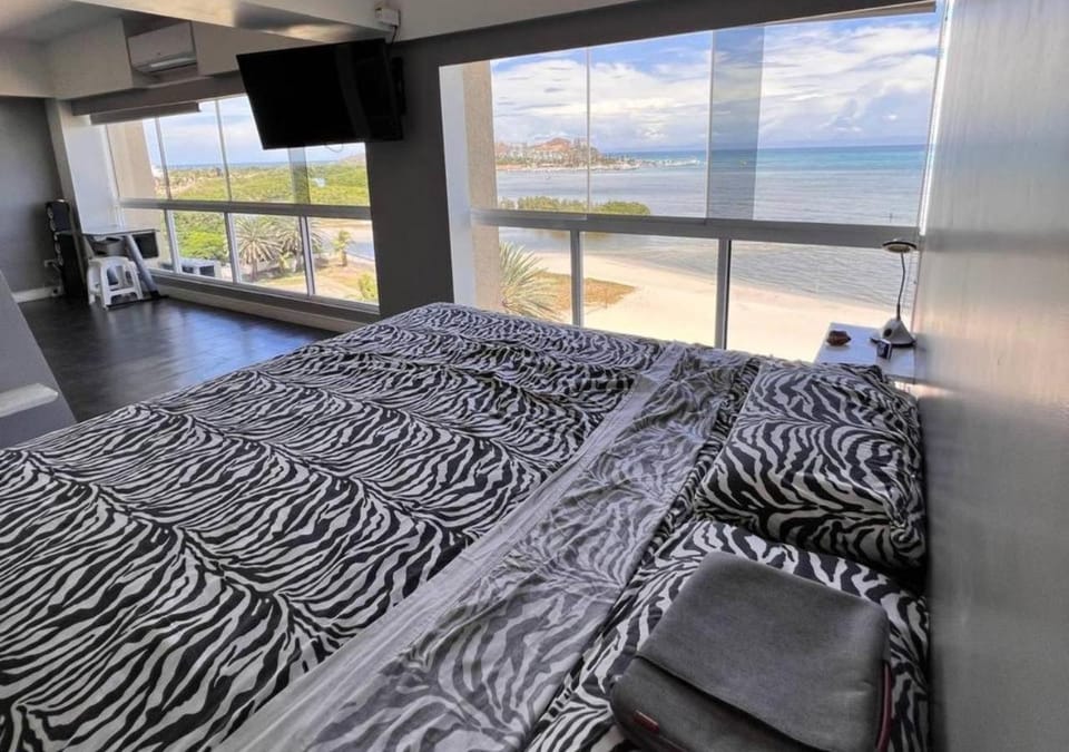 Bed, View (from property/room), Photo of the whole room, Bedroom, Text overlay, Sea view, air conditioner