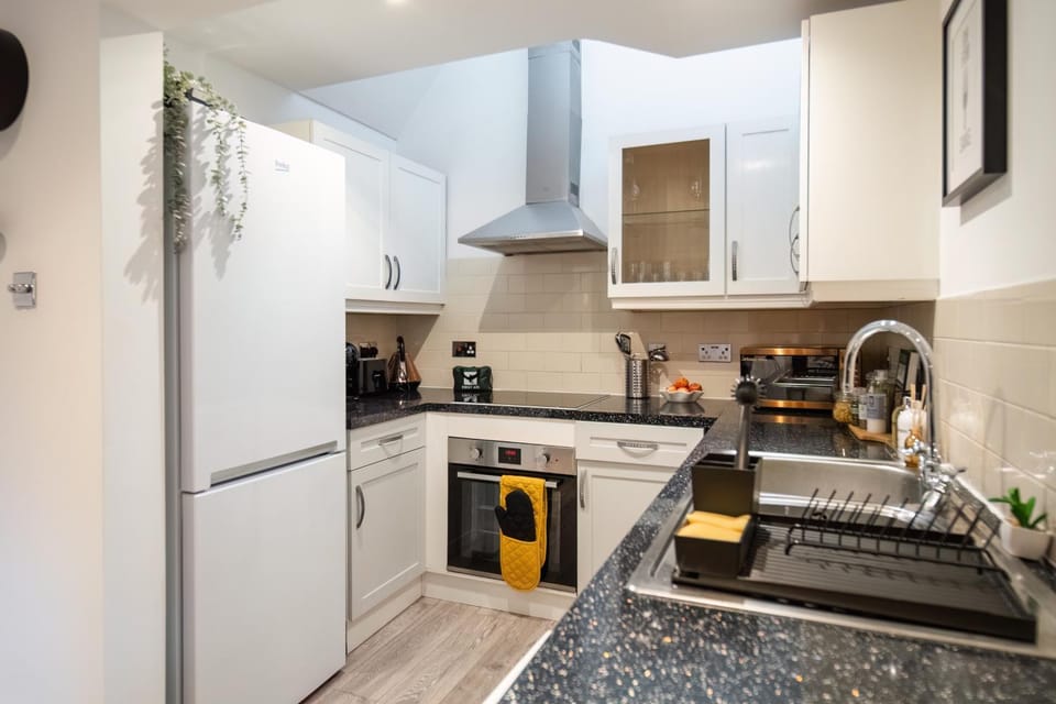 Kitchen or kitchenette, dishwasher, oven, stove, toaster