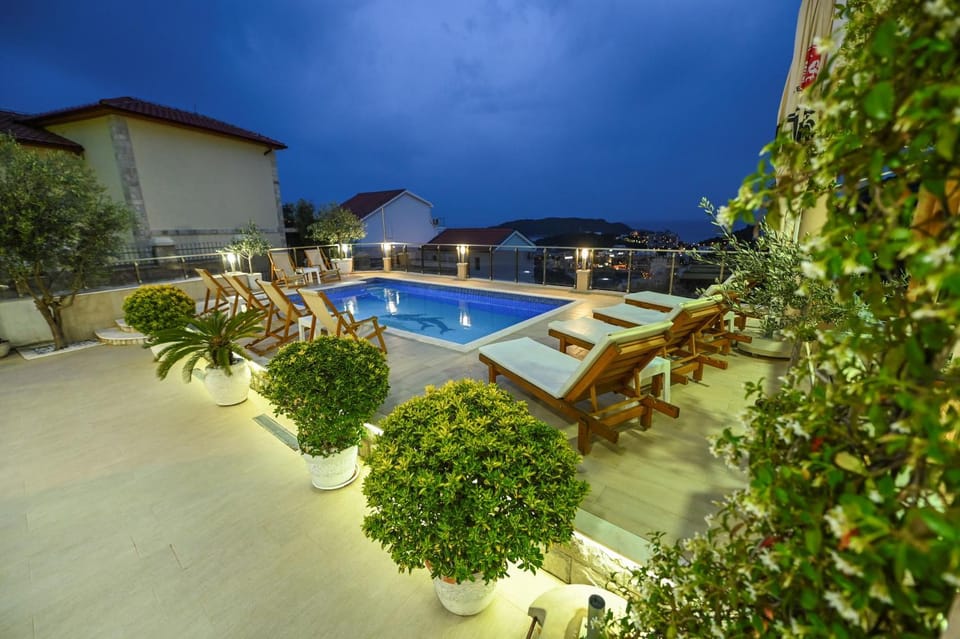 Property building, Patio, Night, Pool view, Swimming pool, sunbed