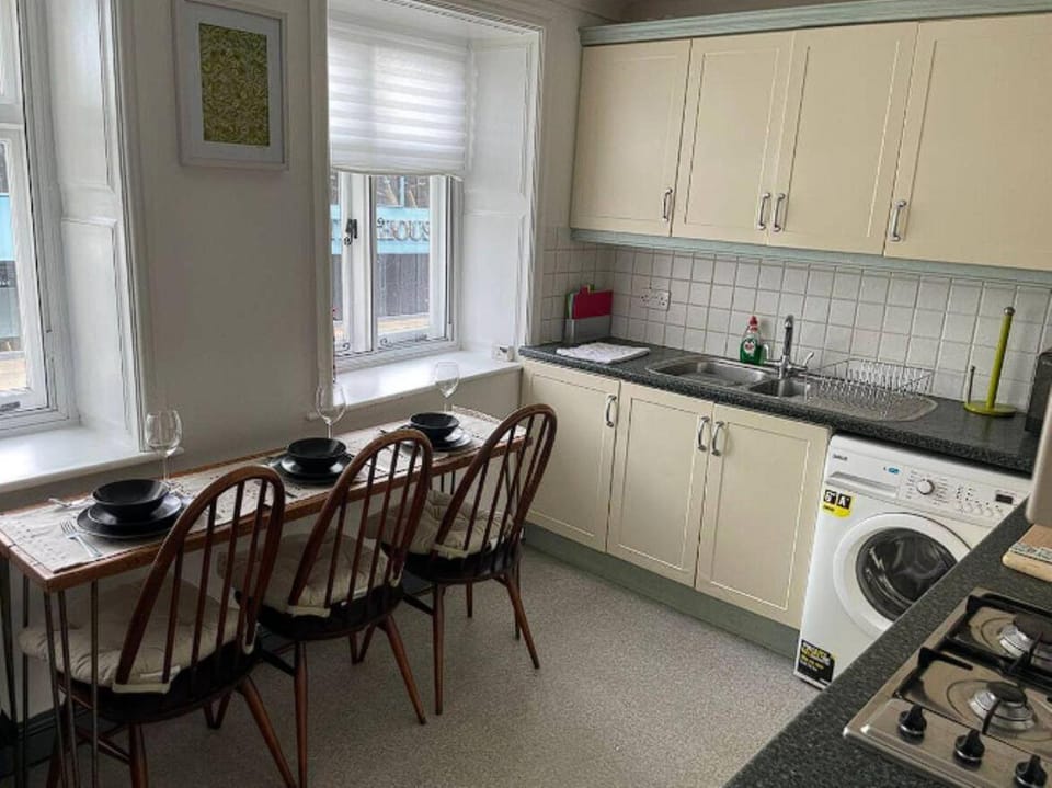 Kitchen or kitchenette, Dining area, oven, stove, toaster, washing machine, dryer