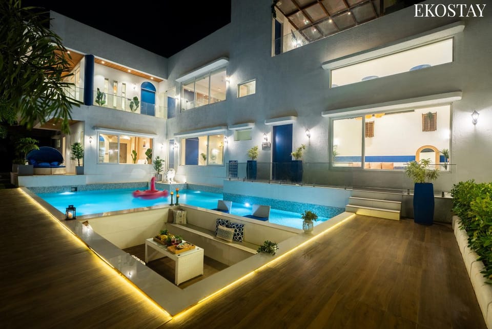 Patio, Night, Living room, Seating area, Pool view, Swimming pool