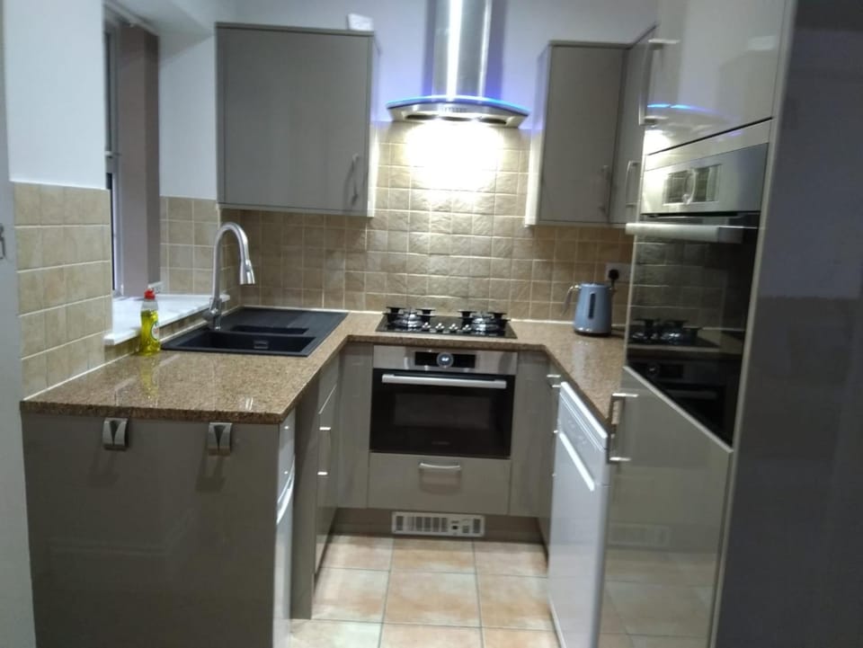 Kitchen or kitchenette, dishwasher, microwave, oven, stove