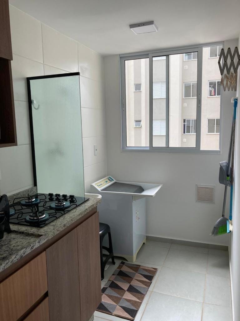 Kitchen or kitchenette, stove, laundry, washing machine