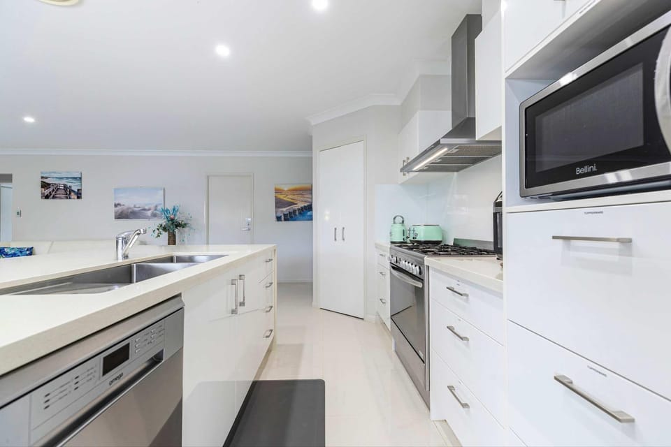 Kitchen or kitchenette, dishwasher, oven, stove