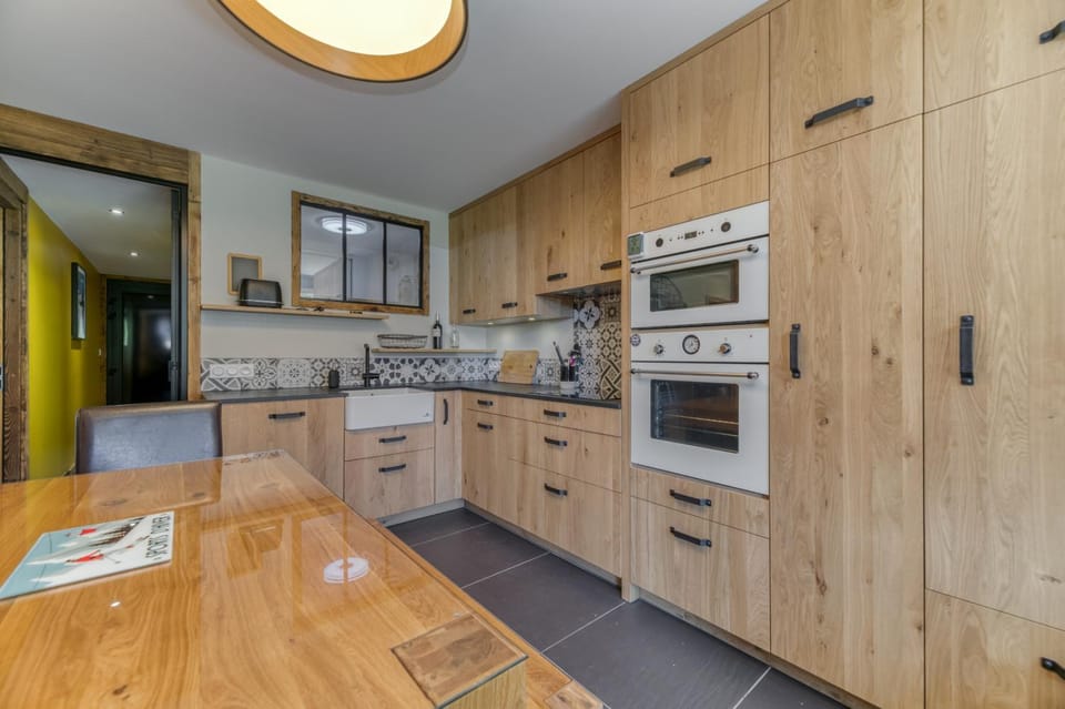Kitchen or kitchenette, dishwasher, oven, stove