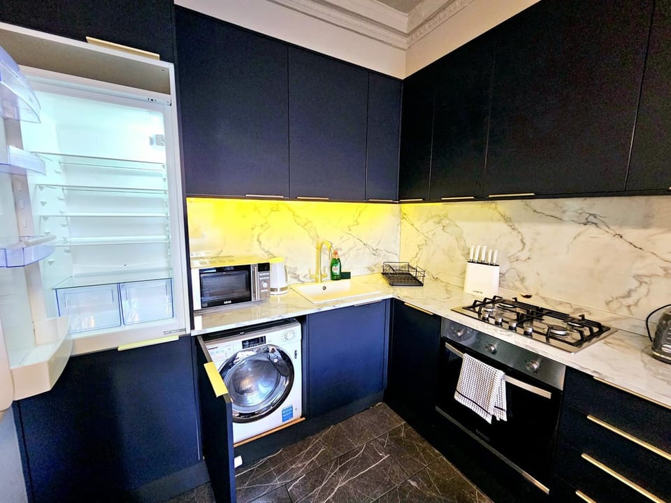 Kitchen or kitchenette, oven, stove, toaster, washing machine, dryer