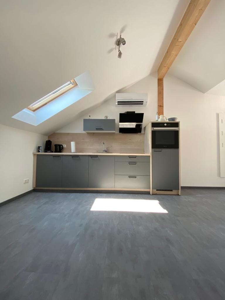 Kitchen or kitchenette, dishwasher, stove, air conditioner