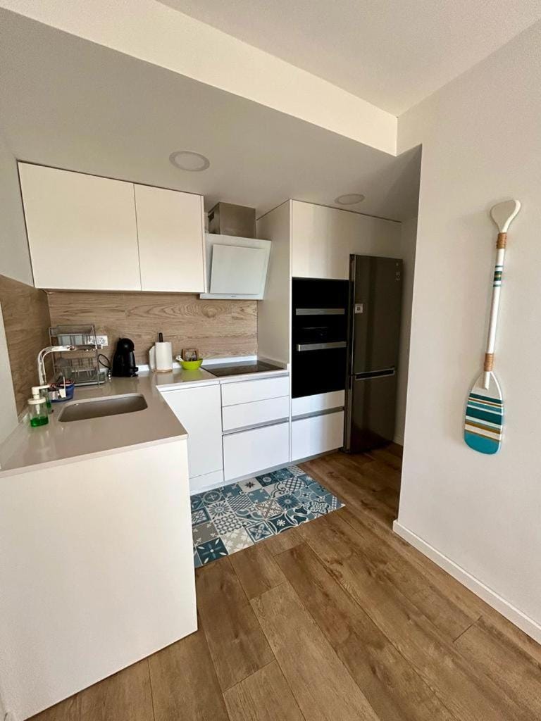 Kitchen or kitchenette, dishwasher, oven, stove