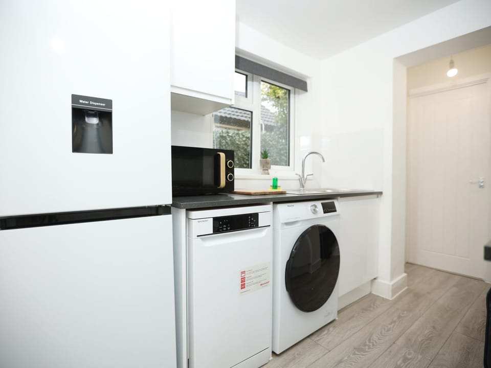 Kitchen or kitchenette, dishwasher, oven, stove, washing machine