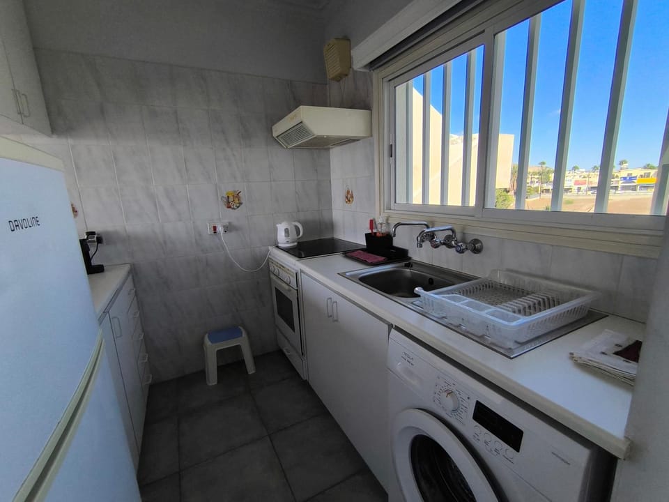 Kitchen or kitchenette, stove, washing machine