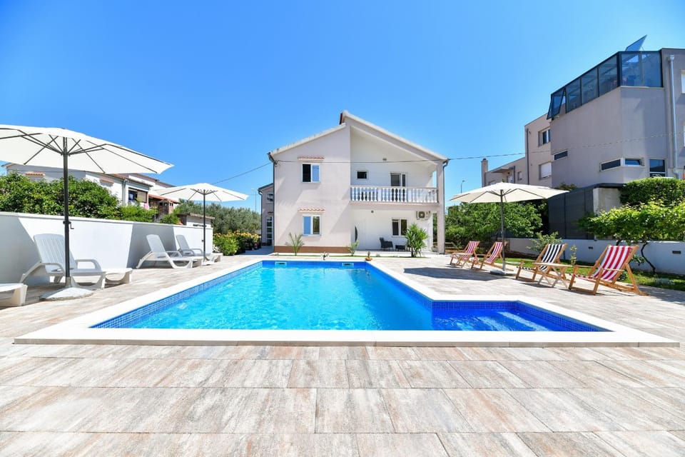 Property building, Patio, Day, Pool view, Swimming pool