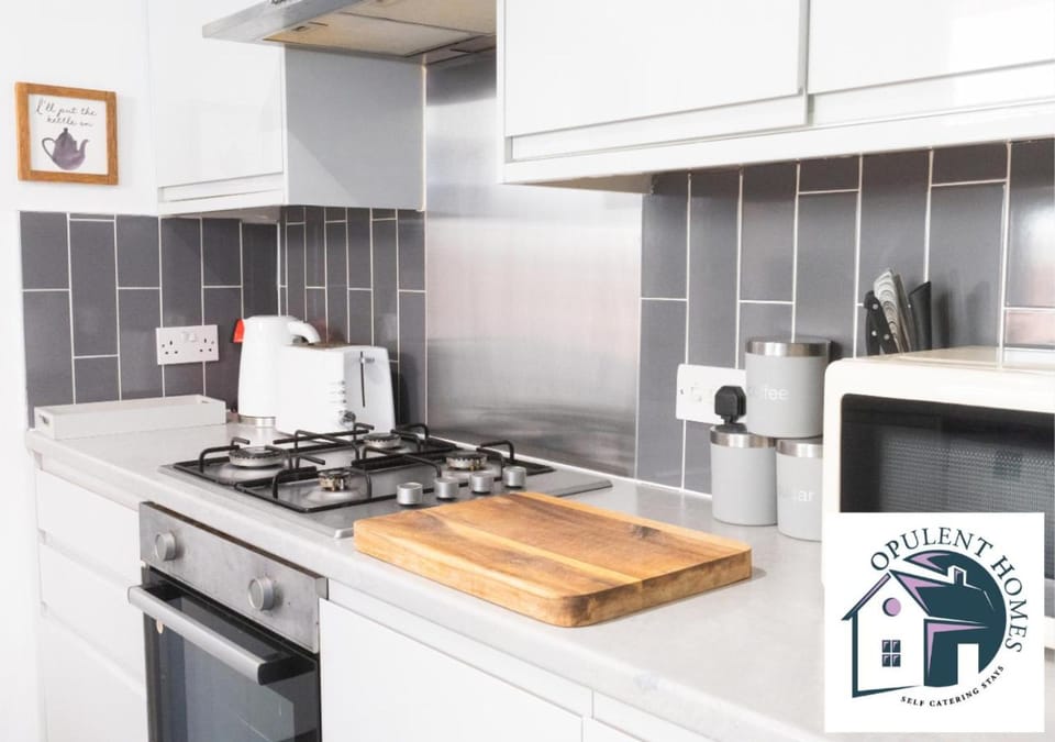 Kitchen or kitchenette, dishwasher, stove, toaster