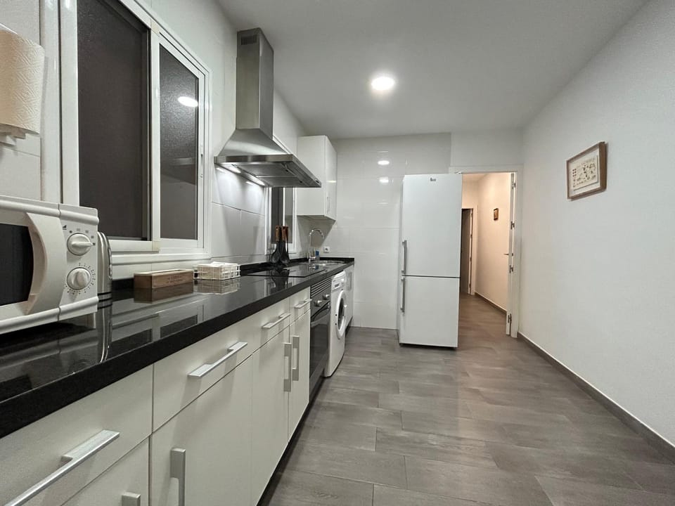 Kitchen or kitchenette, oven, stove, washing machine