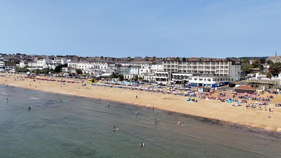 Property building, Nearby landmark, Day, People, Natural landscape, Bird's eye view, Beach, Sea view, sunbed