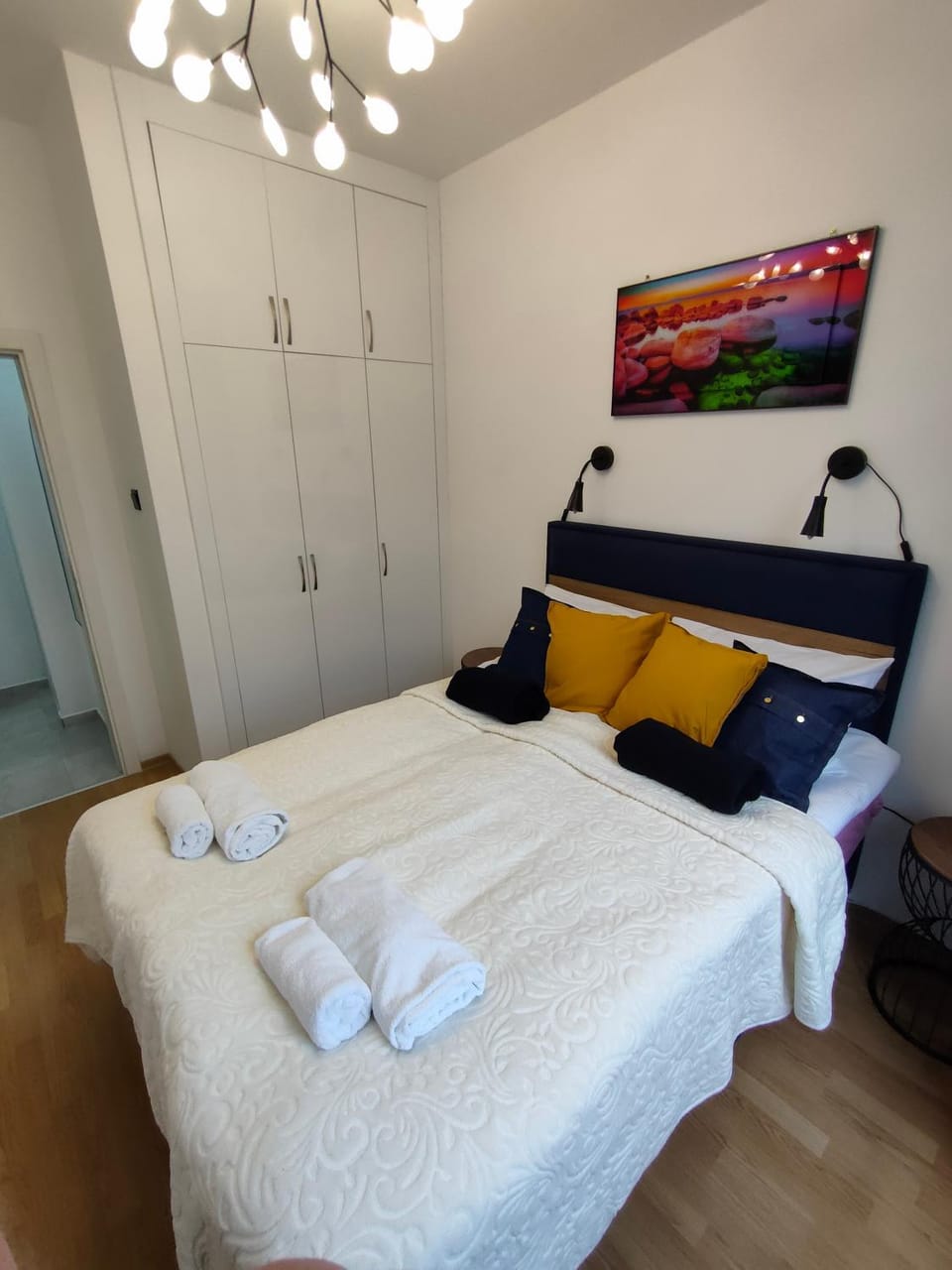 Bed, Photo of the whole room, Decorative detail, Decorative detail, Seating area, Bedroom, towels, wardrobe