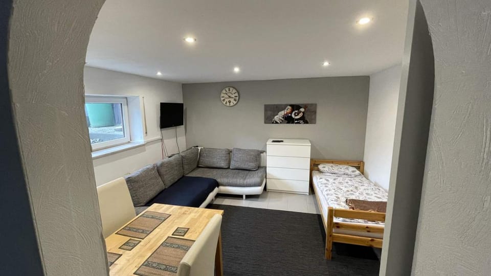 Bed, TV and multimedia, Living room, Seating area, Bedroom