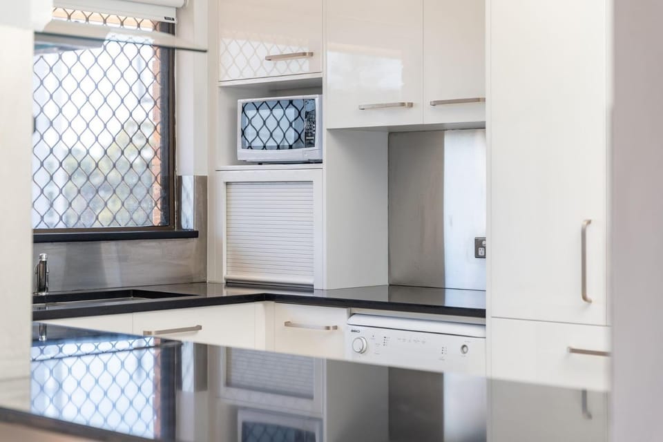 Kitchen or kitchenette, dishwasher, oven, stove