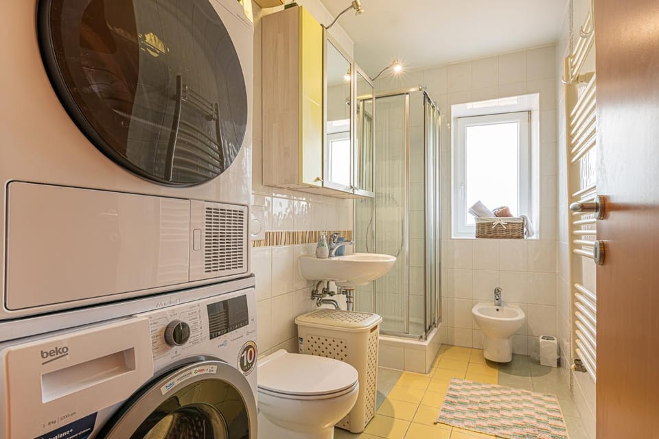 Shower, Toilet, Bathroom, bidet, towels, washing machine, dryer