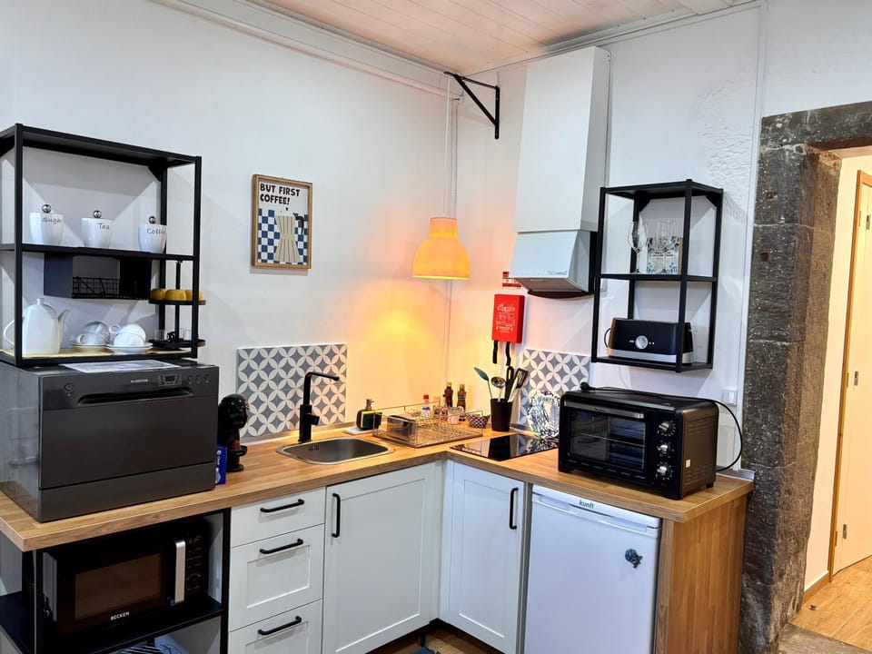 Kitchen or kitchenette, dishwasher, oven, stove