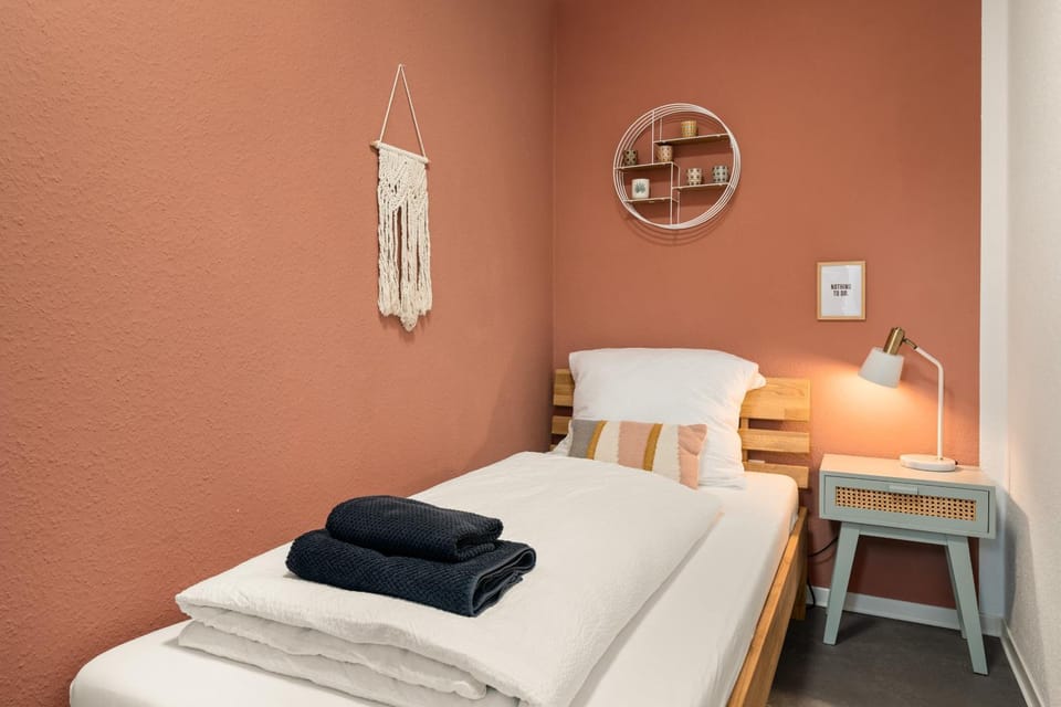 Bed, flat iron, storage, towels, wardrobe