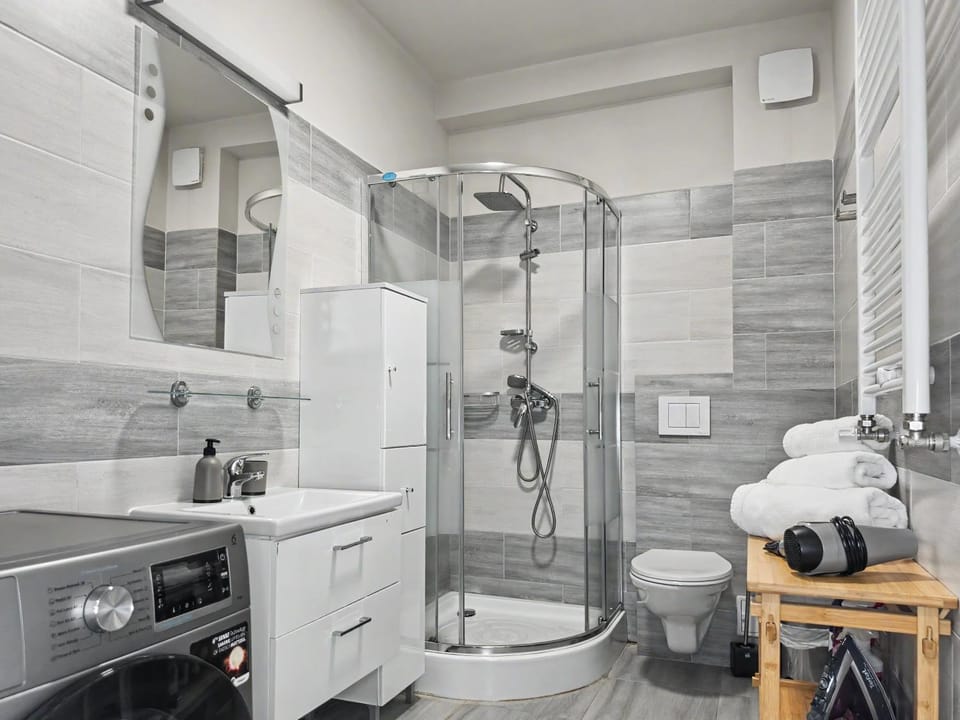 Shower, Toilet, Bathroom, flat iron, hair dryier, towels, washing machine