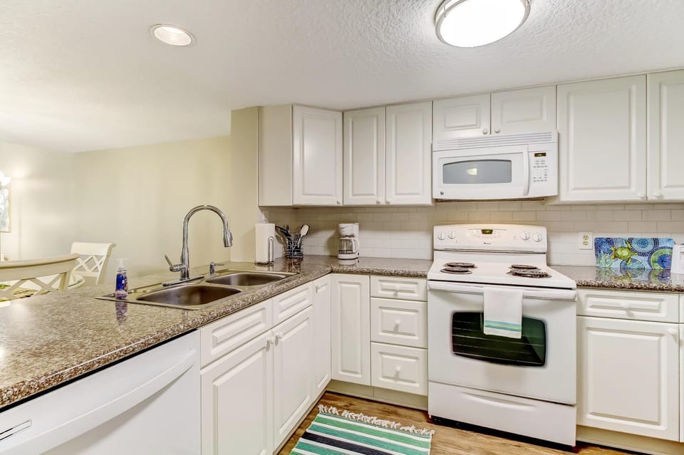 Kitchen or kitchenette, dishwasher, oven, stove