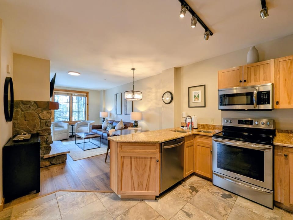 Kitchen or kitchenette, Living room, Seating area, fireplace, furniture, microwave, oven, stove, toaster