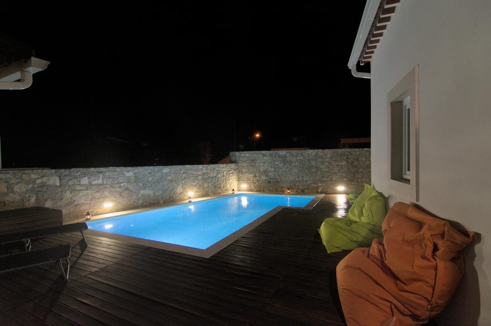 Patio, Night, Pool view, Swimming pool, sunbed