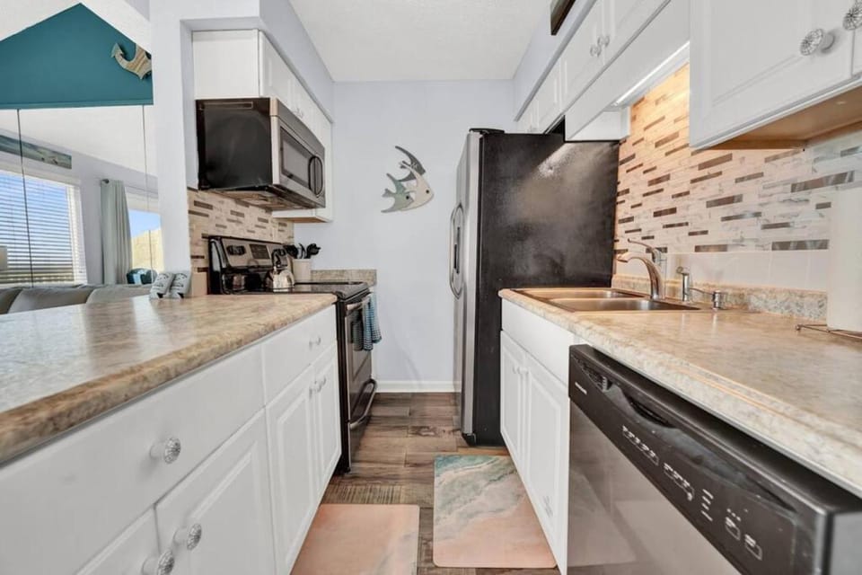 Kitchen or kitchenette, dishwasher, microwave, oven, stove