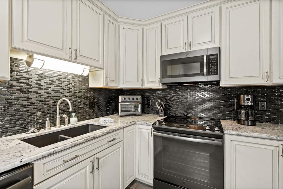 Kitchen or kitchenette, dishwasher, oven, stove, toaster