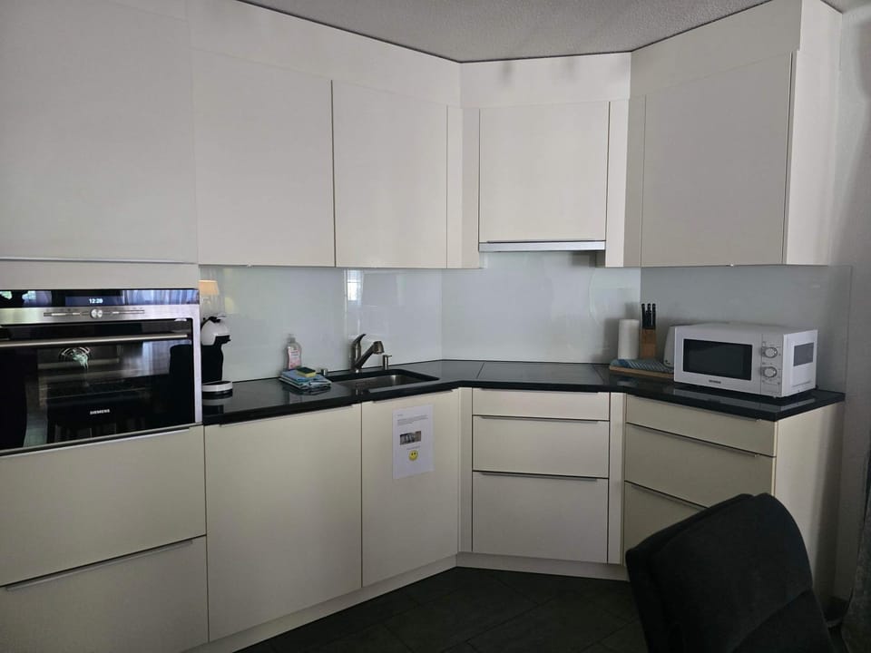 Kitchen or kitchenette, dishwasher, oven, stove