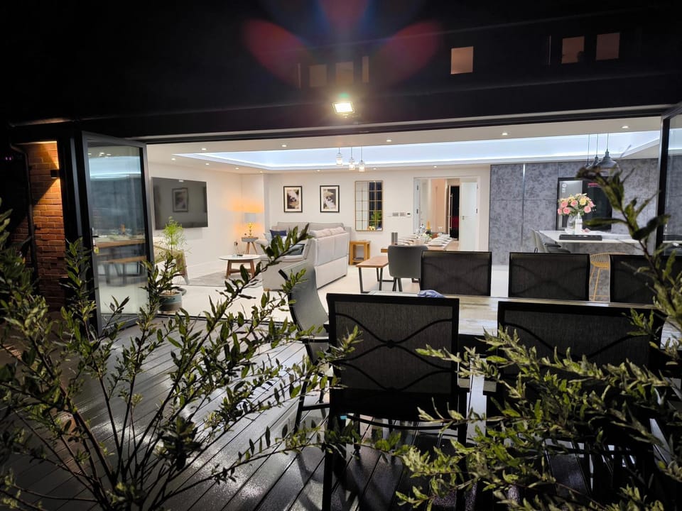 Property building, Patio, Night, Garden, Living room, Seating area, Dining area, Garden view