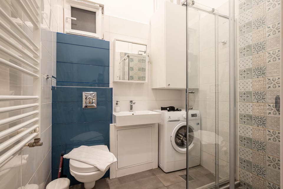 Shower, Toilet, Bathroom, hair dryier, towels, washing machine, dryer
