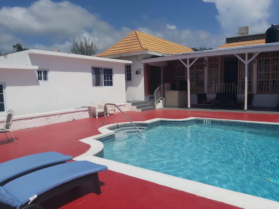 Property building, Patio, Pool view, Swimming pool, sunbed