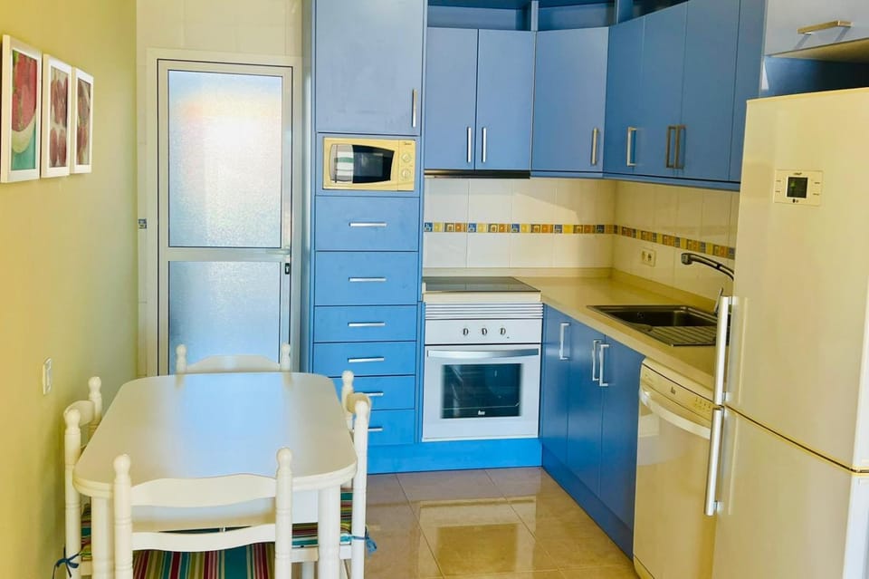Kitchen or kitchenette, dishwasher, microwave, oven, stove