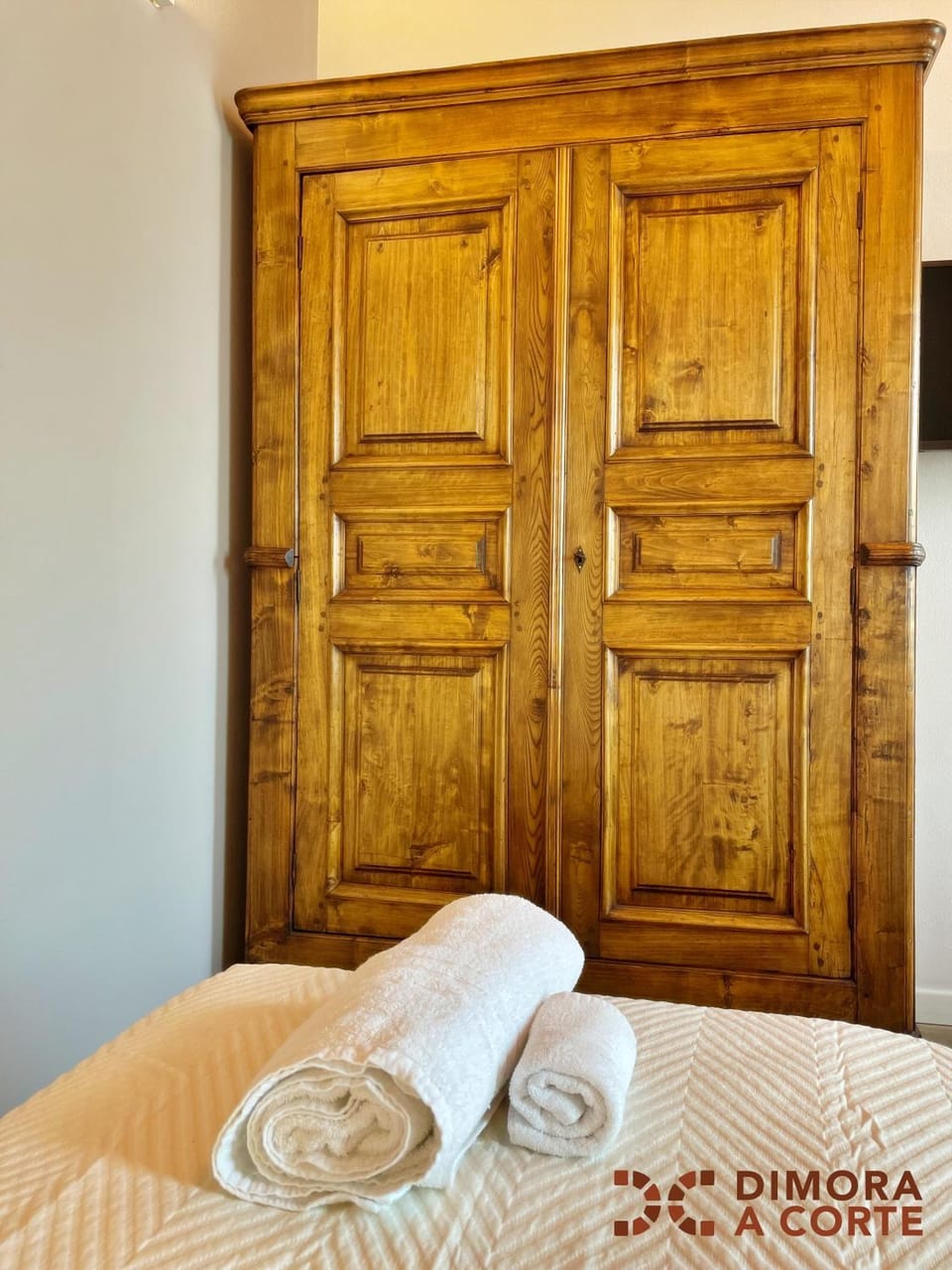 Bed, towels, wardrobe