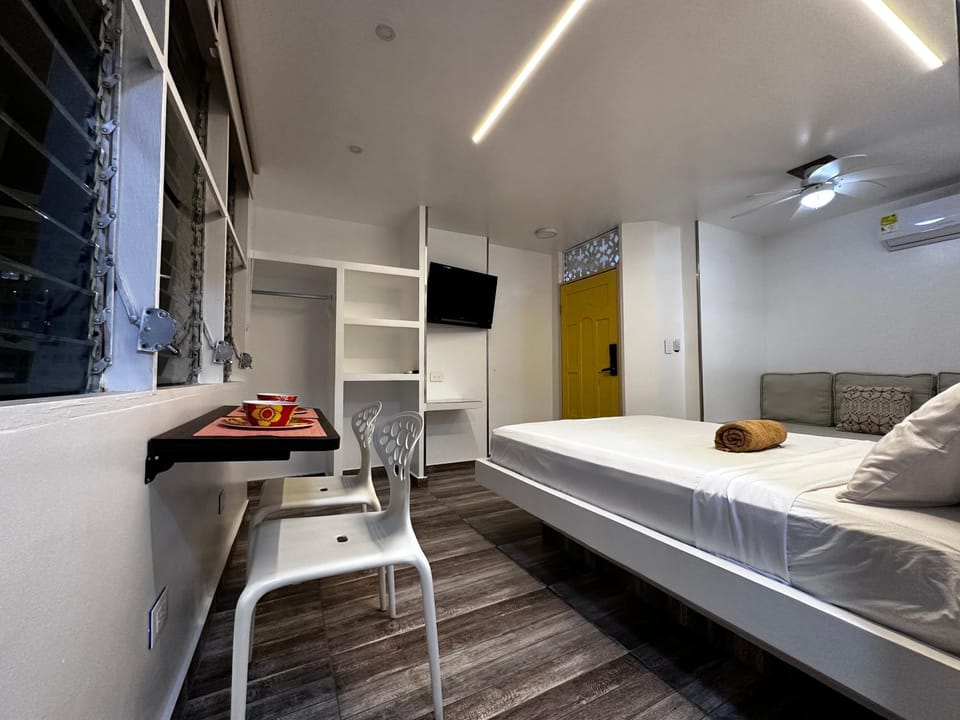 Communal lounge/ TV room, Bed, TV and multimedia, Living room, Photo of the whole room, Seating area, Bedroom, fireplace, wardrobe, air conditioner