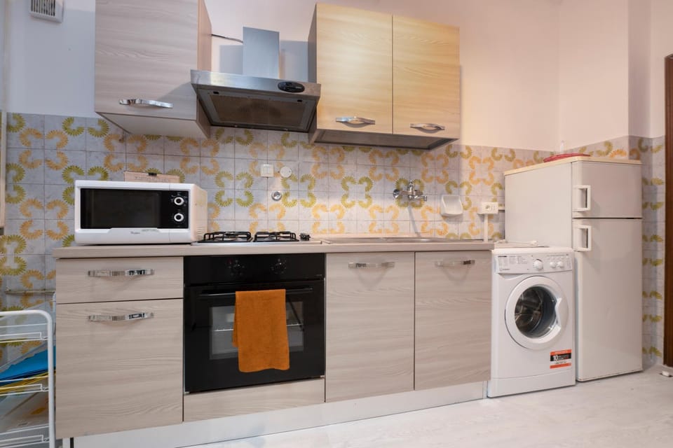 Kitchen or kitchenette, oven, stove, washing machine